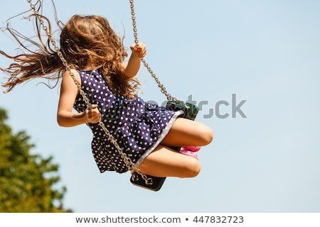 Boy and girl swinging on a rope
